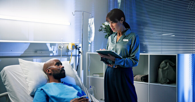 Tablet, consultation and doctor with man in hospital for surgery recovery, healing or advice. Medical feedback, digital technology and surgeon with male patient for checkup with support in clinic.