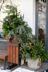 Christmas street decorations. Branches of spruce, fir, pine, cones decorating the entrance to the store.