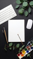 Workspace flat lay paper, paints, keyboard, greenery
