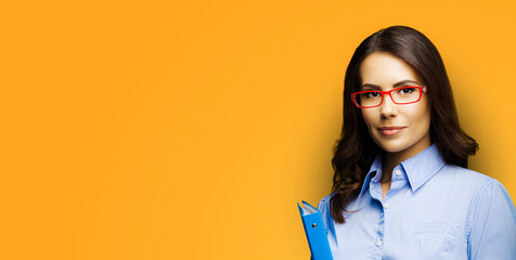 Wide banner image - brunette cute businesswoman woman bank manager, real estate sale agent, lawyer wear red eye glasses, holding blue folder, isolated orange yellow background with free ad text space