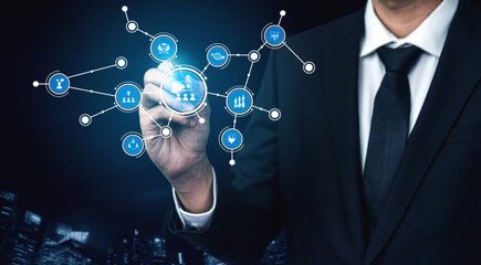 A businessman interacts with a digital network visualization, showcasing the concept of technology connection and data sharing in a modern corporate environment. Tessel