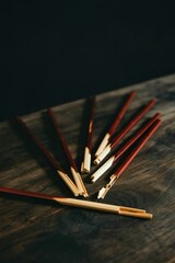 Chocolate dipped pretzel sticks on a rustic wooden surface
