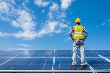 Technician inspects solar panels under bright blue sky, showcasing renewable energy technology. scene reflects dedication to sustainable practices and innovation in energy solutions