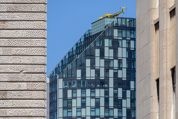 Modern Curved Glass High-Rise Framed by Two Textured Stone Walls