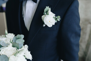 Groom in navy suit with wedding boutonniere