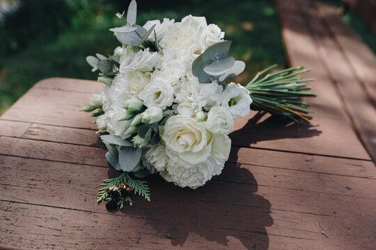 Blooming wedding bouquet with golden rings