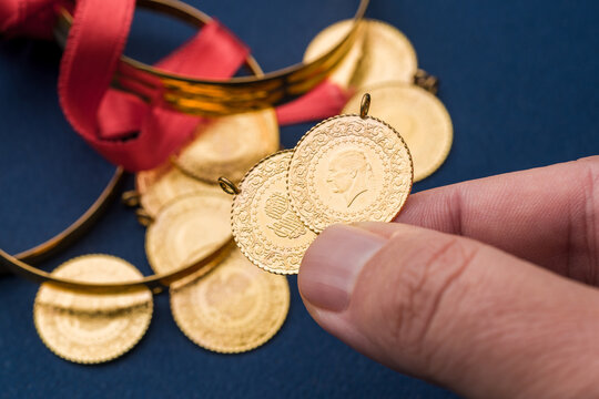 Traditional Turkish half gold coins and bracelets symbolizing wealth and prosperity