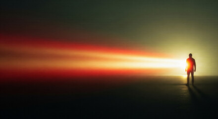Obraz premium A lone person stands illuminated by a vibrant, streaking light in a dark space
