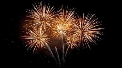 A dazzling display of golden fireworks bursts and light trails illuminates the dark night sky during a festive celeb n