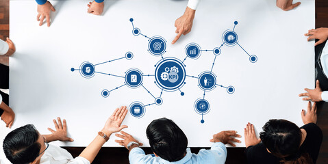 A group of business professionals engaging in discussion around key performance indicators, illustrated with analytics icons, emphasizing teamwork and strategic planning. Amity