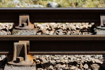 Close-up of metal railway line tracks and track ballast