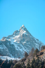 Snow-Capped Mountain Peak Rising Against Blue Sky, Sichuan China