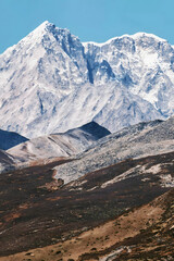 Majestic Snow-Capped Alpine Peaks Above Barren Desert Highlands