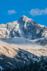Majestic Snowcapped Alpine Mountain Peak Rising Above Valley