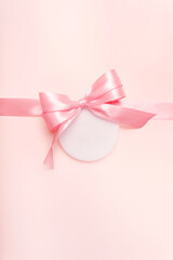 Pink background with ribbon, bow and round tag label, vertical mockup