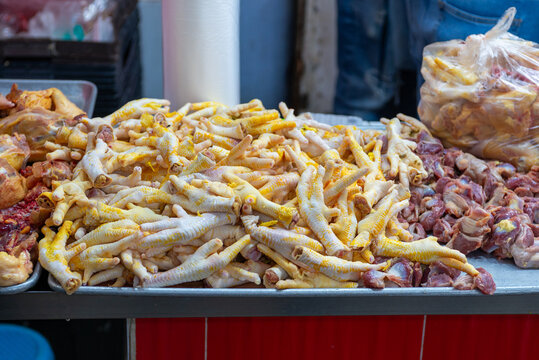 Close Up Pile of Raw Chicken Feet and Giblets for Sale
