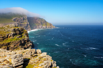 View of Cape Point from the Cape of Good Hope with the upper lighthouse (built in 1859) shrouded in mist, which is why in 1919,  the lower one was built. Cape Town. Western Cape. South Africa.