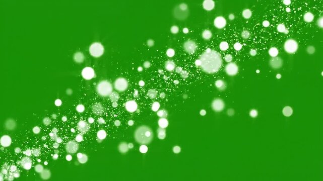 Ethereal white bokeh lights sparkle and dance against a vibrant green background, creating a magical and festive atmosphere.