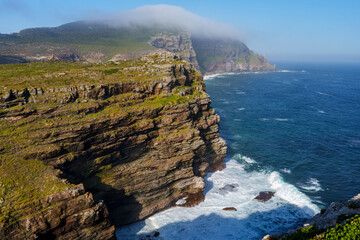 View of Cape Point from the Cape of Good Hope with the upper lighthouse (built in 1859) shrouded in mist, which is why in 1919,  the lower one was built. Cape Town. Western Cape. South Africa.