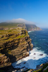 View of Cape Point from the Cape of Good Hope with the upper lighthouse (built in 1859) shrouded in mist, which is why in 1919,  the lower one was built. Cape Town. Western Cape. South Africa.
