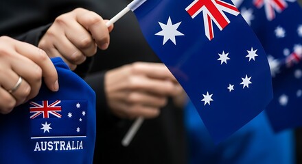 Closeup of hands holding small australian flags, symbolizing national pride and celebration of australia day