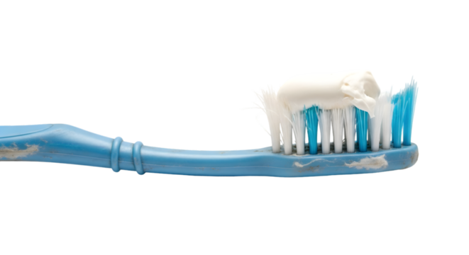 toothbrush with worn bristles and toothpaste residue isolated on white background.