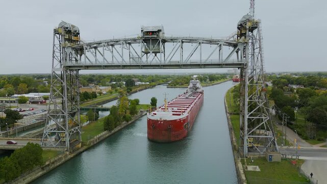 A giant boat laker travels through the Welland Canal, underneath the Port Colborne Clarence Street Bridge.