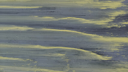 Abstract, painted texture broad, horizontal streaks dark blue-gray or slate and contrasting highlights dull yellow. Brushstrokes or stripes create dynamic, wavy pattern that suggests motion