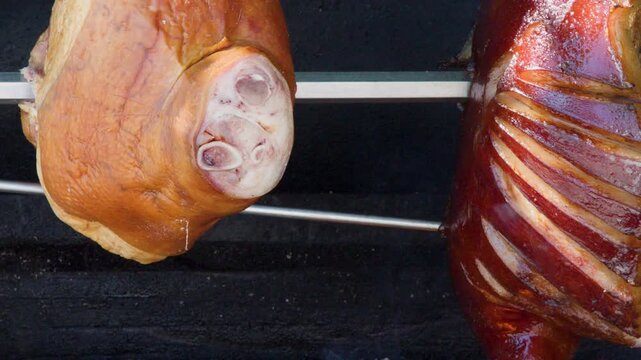 Pork Knuckles Rotating on Grill Over Open Flame in Prague