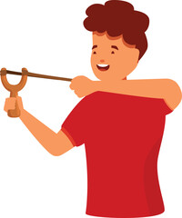 Cheerful boy concentrating and aiming while using a wooden slingshot, playing and having fun outdoors