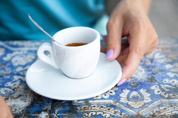 Interior designer relaxes sipping coffee among colorful fabric swatches
