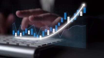 A business professional analyzes financial data on a computer screen, showcasing graphical trends that signify growth and investment success. Copula