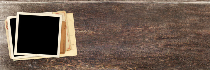 Horizontal banner with two retro photo, vintage envelope and cards on wooden board. Nostalgic scrapbooking mockup template is perfect way to express creativity and evoke a sense of warm memories