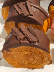 A delightful chocolate-covered pastry sits invitingly on a sleek, making it the perfect treat for any sweet tooth.