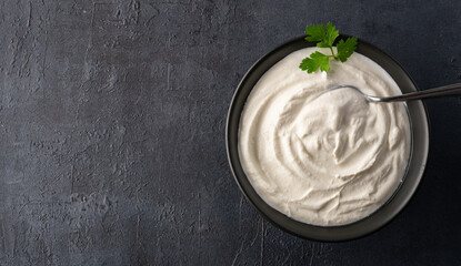 Traditional yogurt, full-fat or nonfat. Yogurt made from cow's or goat's milk on black background