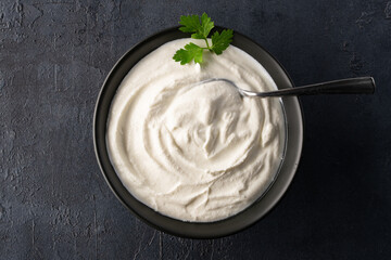 Traditional yogurt, full-fat or nonfat. Yogurt made from cow's or goat's milk on black background