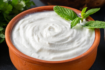 Traditional yogurt, full-fat or nonfat. Yogurt made from cow's or goat's milk on black background