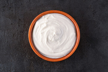 Traditional yogurt, full-fat or nonfat. Yogurt made from cow's or goat's milk on black background	
