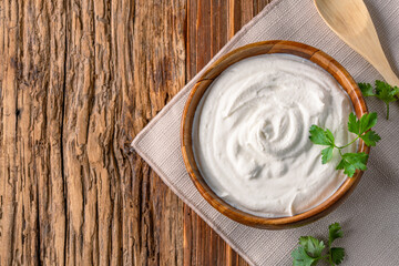 Traditional yogurt, full-fat or nonfat. Yogurt made from cow's or goat's milk on wooden background