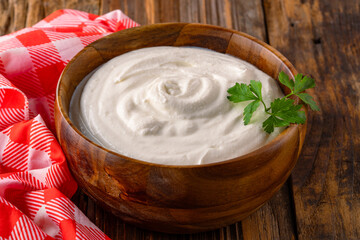 Traditional yogurt, full-fat or nonfat. Yogurt made from cow's or goat's milk on wooden background