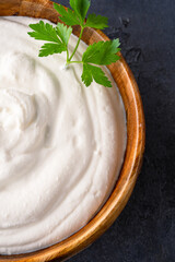 Traditional yogurt, full-fat or nonfat. Yogurt made from cow's or goat's milk on black background