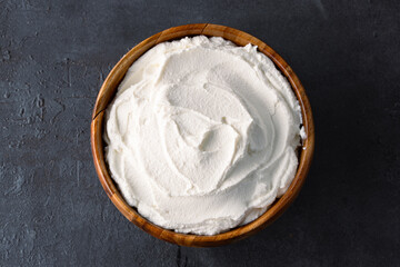 Traditional yogurt, full-fat or nonfat. Yogurt made from cow's or goat's milk on black background	
