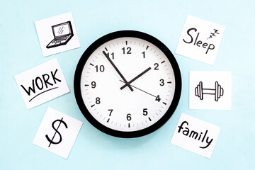 Wall clock and many paper cards with hand drawing of different life activities, top view. Time...