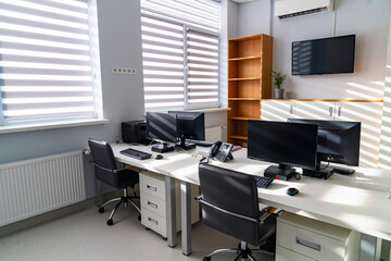 Clean clinical workspace view. Clean clinical workspace with organized desks and equipment for daily duties.