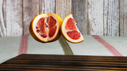 Floating Grapefruit Halves in Midair on Rustic Background