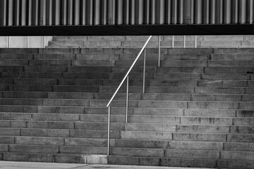 minimalist black and white staircase with metal handrail