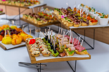 Colorful buffet appetizers on stands. Vibrant buffet arrangement with assorted appetizers served on modern stands.