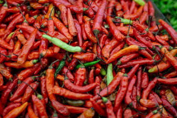 Pile of Fresh Red and Green Chili Peppers at Market
