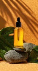 Oil bottle on stones with leaf shadows on an orange backdrop