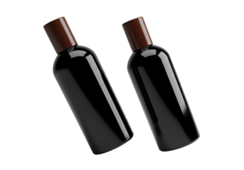 Two dark bottles with brown caps floating on a black background in studio shot